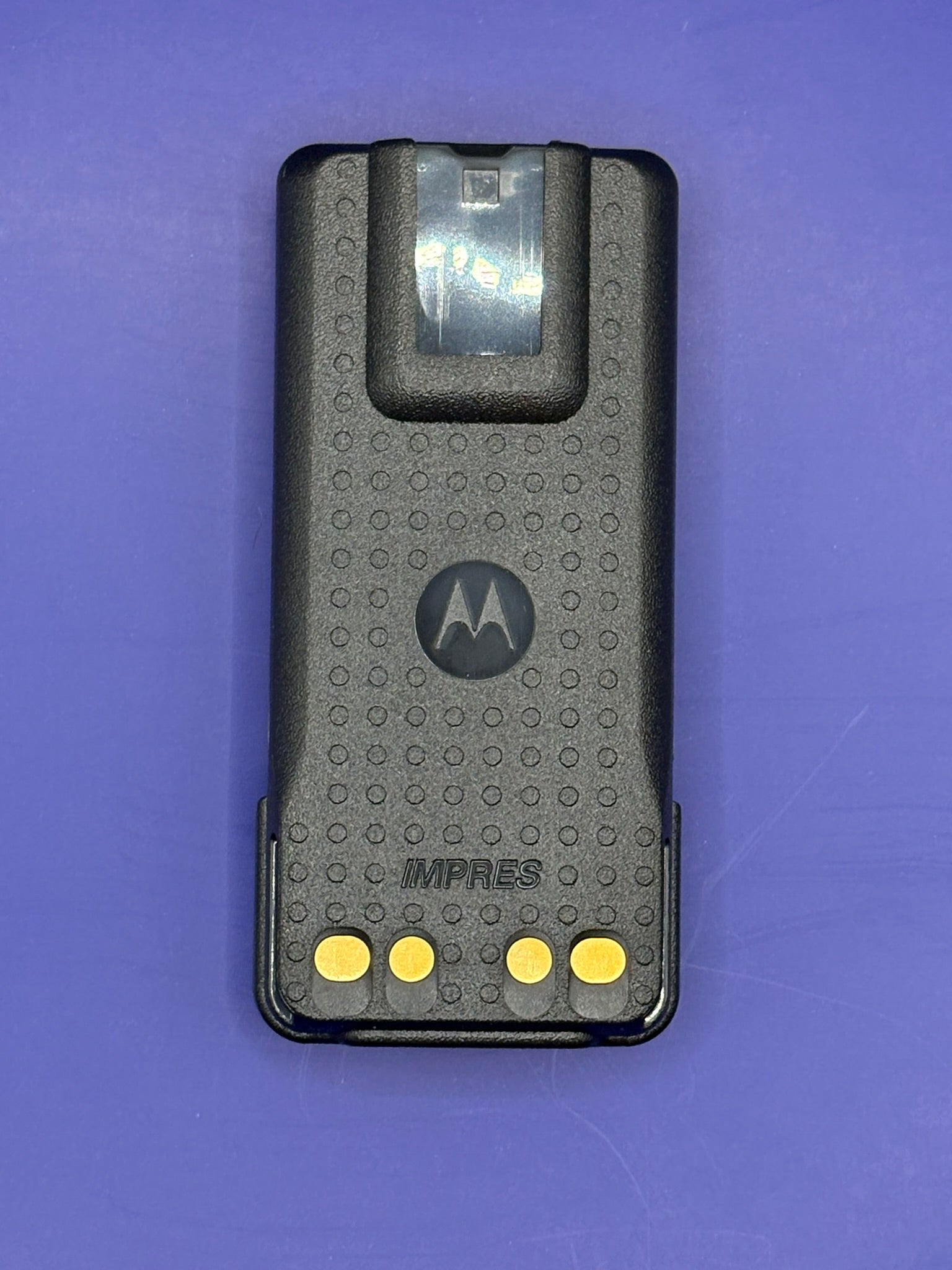 Motorola IMPRES device on a purple background
