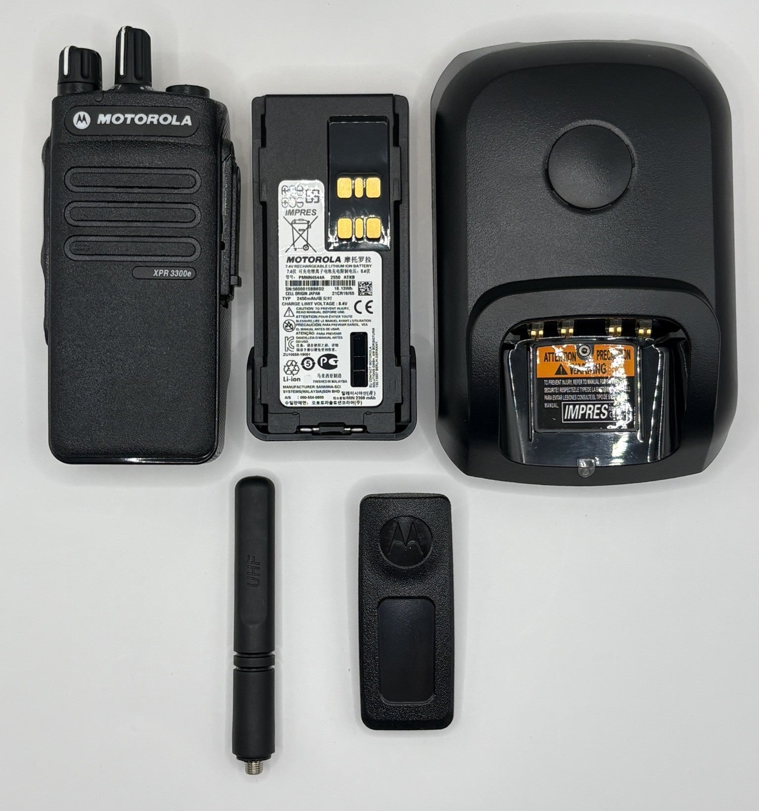 Motorola radio equipment including a radio, battery, charger, and accessories on a white background